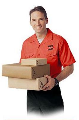 A Hot Shot Delivery employee wearing a uniform and carrying three packages in the middle of a delivery service.